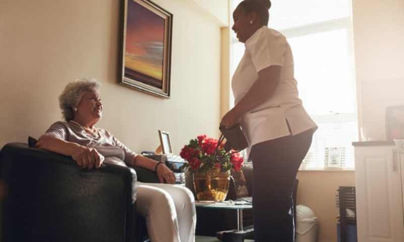 Careworker talking to a service user. Photo Guardian